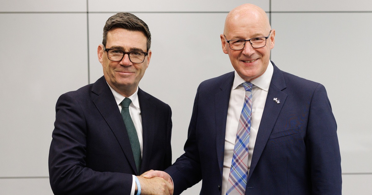 Andy Burnham shaking hands with John Swinney during a visit to Glasgow in July 2026